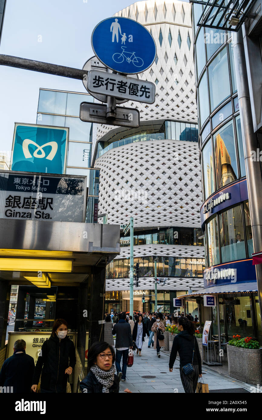 Tokyo, Ginza. Menschen, die von der U-Bahnstation Ginza Ausgang neben "Le Cafe Douttor, während im Hintergrund ist die Ginza, weißes Gebäude. Daytim Stockfoto