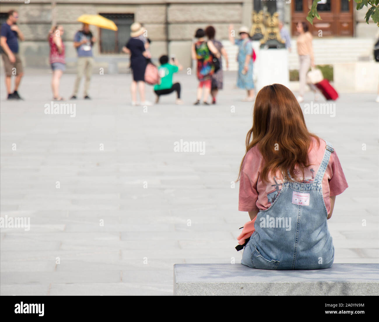 Belgrad, Serbien - September 12, 2019: Ein junger Teenager mit Ingwer Haar in Jeans insgesamt sitzen und warten auf City Bank am Marktplatz, und Stockfoto