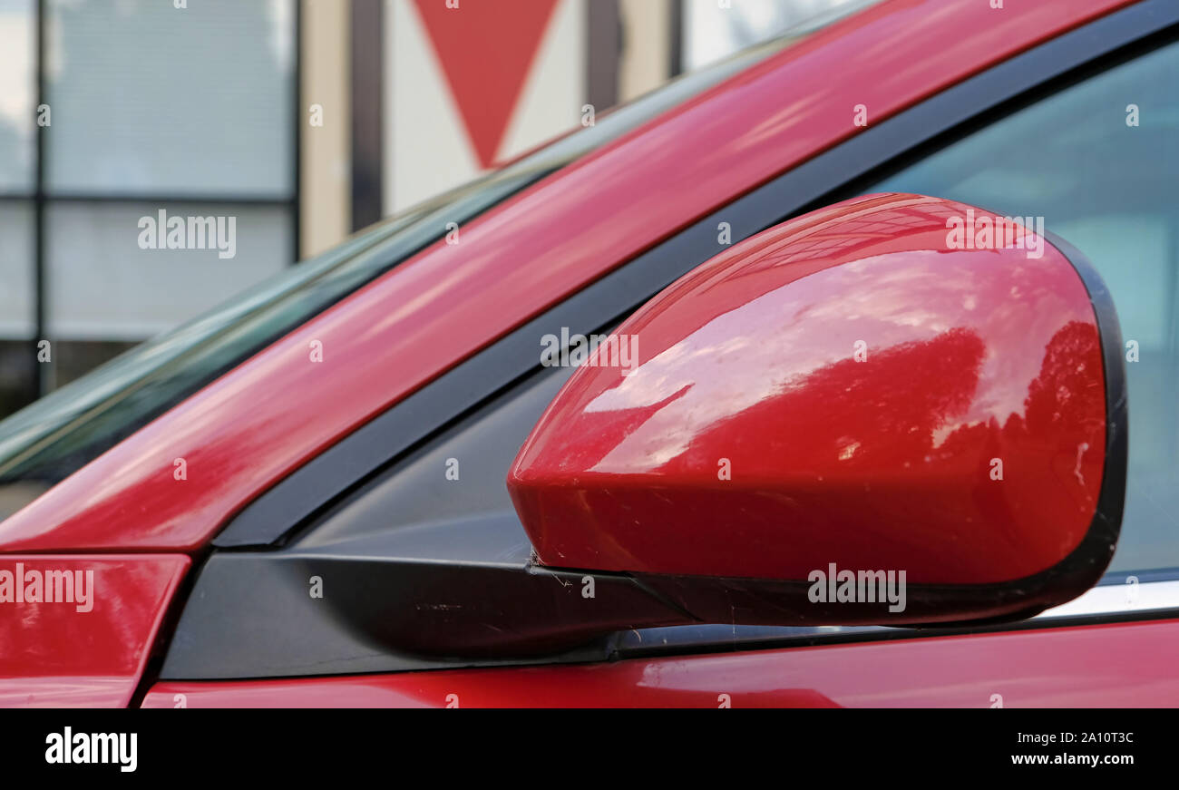 Die Rückspiegel der roten Auto. Die linke Seite des Autos. Gegen einen holländischen Gebäude in Amsterdam Die Niederlande Stockfoto