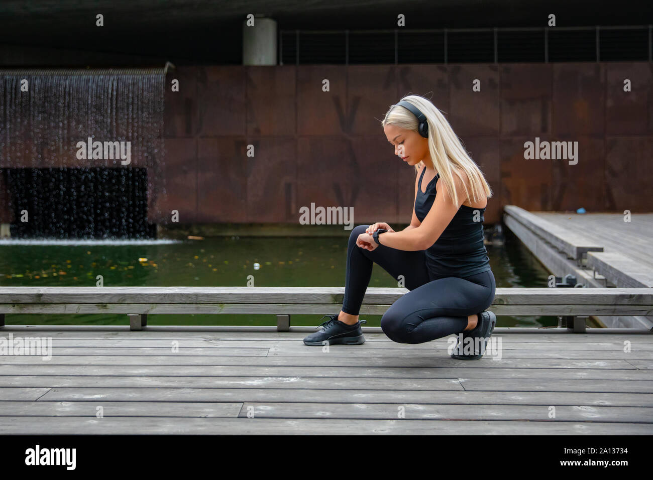 Schöne Fitness Frau mit Smartphone-Uhr Stockfoto