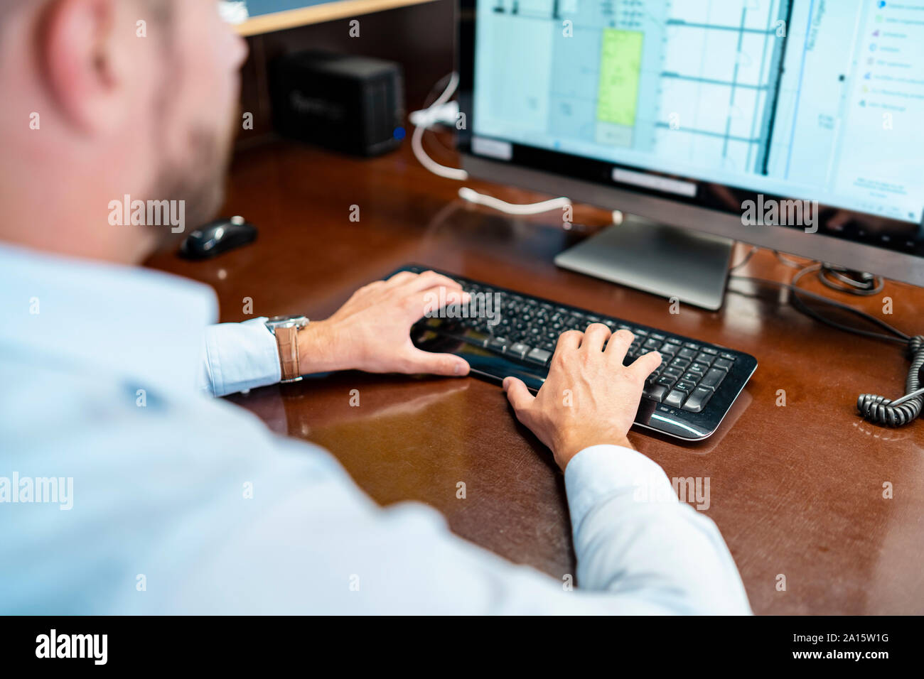 Nahaufnahme des Geschäftsmanns, der auf dem Desktop-PC im Büro Stockfoto