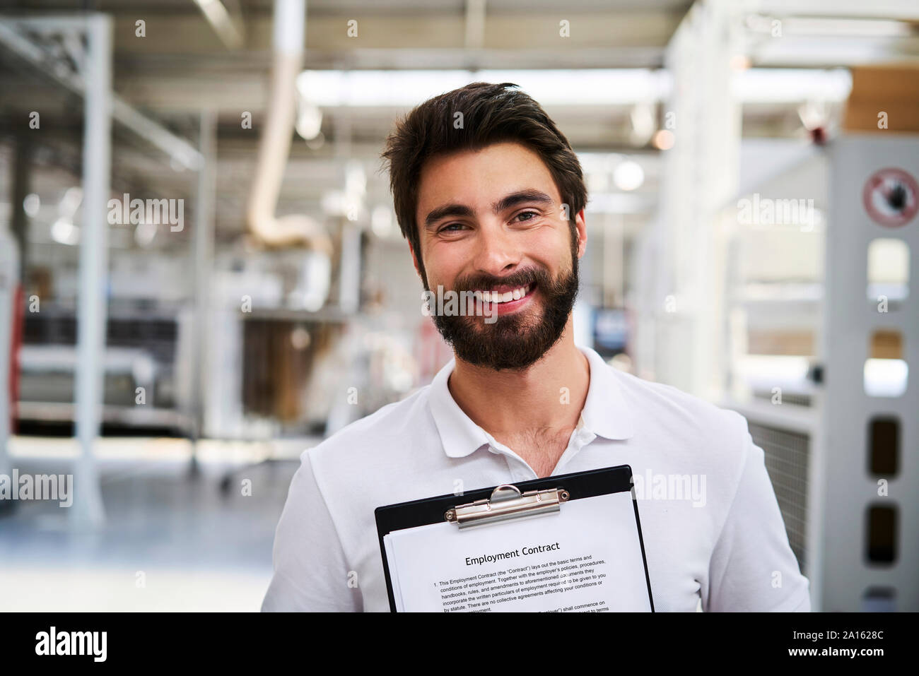 Portrait von Happy Mitarbeiters, der Arbeitsvertrag in einer Fabrik Stockfoto