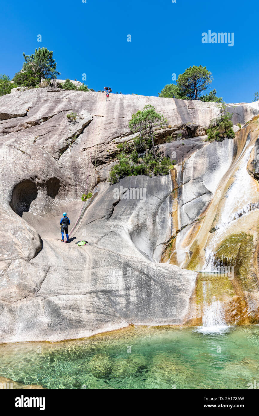 Menschen Canyoning in der berühmten Purcaraccia Canyon in Bavella im Sommer, eine touristische Destination und Attraktion für Canyoning, Wandern und Besichtigen. Stockfoto