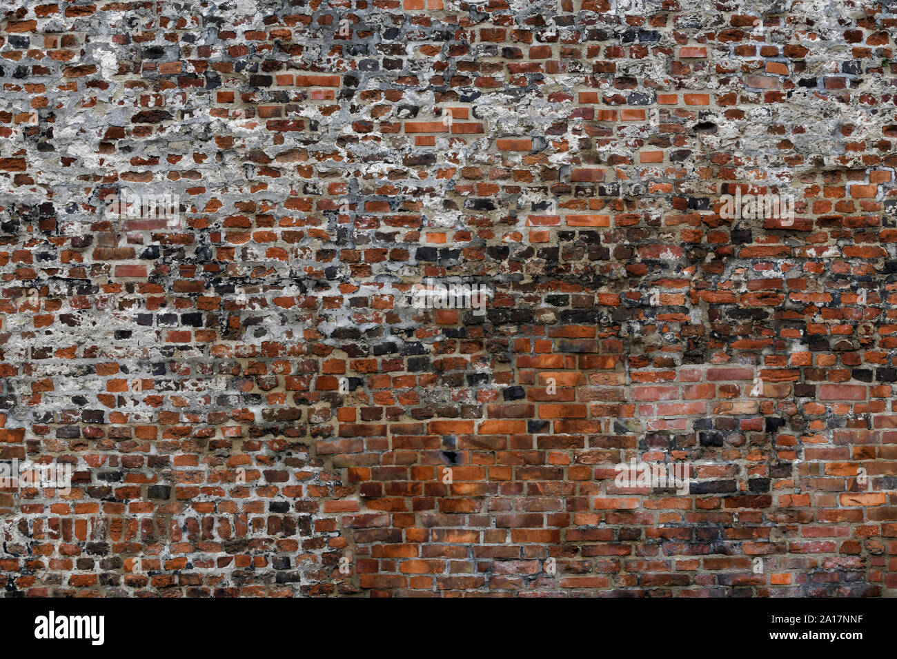 Old Red Brick Wall mit viel Struktur und Farbe. Stockfoto