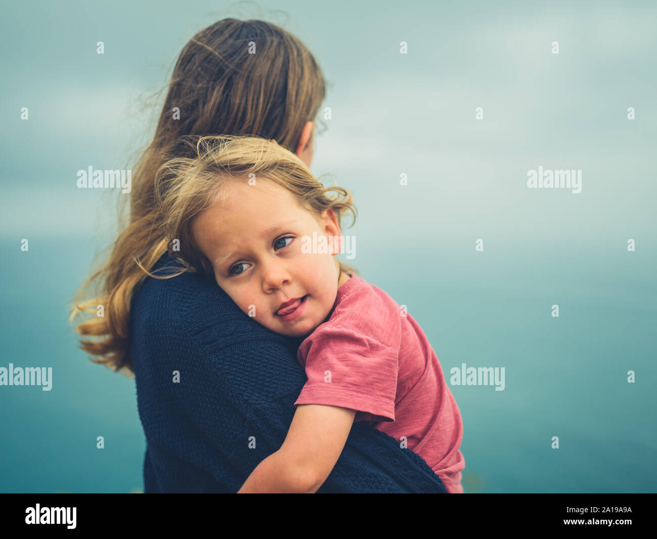 Eine junge Mutter mit ihrem Kind im Nebel vom Meer Stockfoto