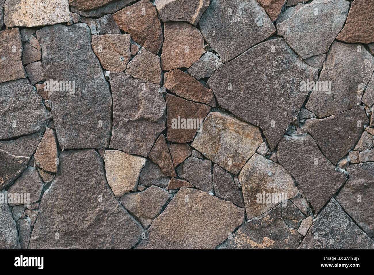 Abstrakte steinerne Mauer Textur. Grauen rock Hintergrund. Hintergrund. Retro Style. Texturierte Oberfläche. Fassade, Gebäude details. Mosaik von Backsteinen. Grau grunge Stockfoto
