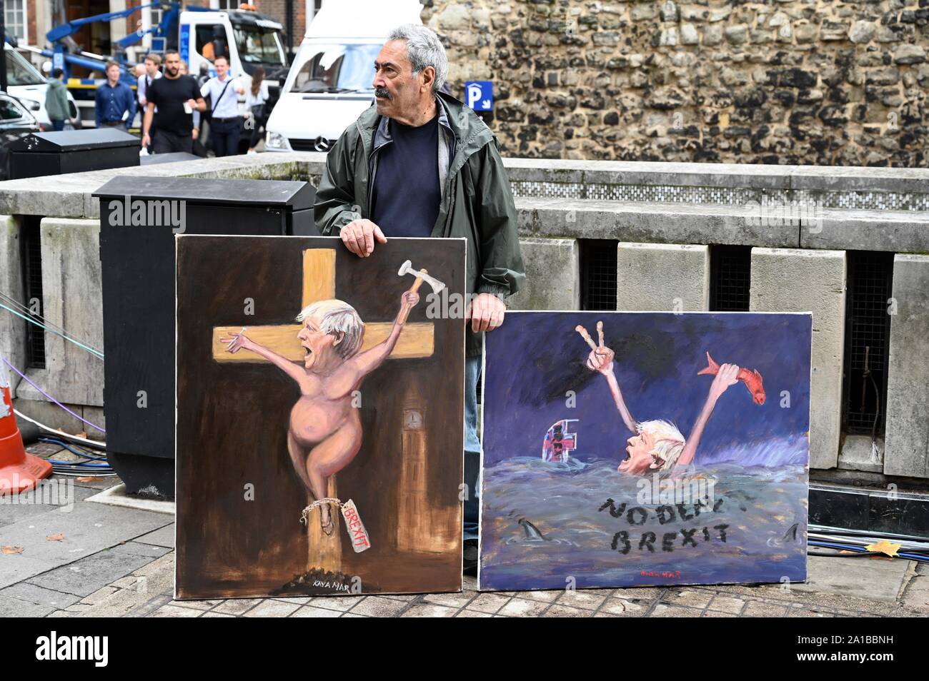 Kaya März politischer Künstler mit zwei Gemälde, die Boris Johnson auf den Tag, an dem das Parlament daran erinnert wurde. College Green, Houses of Parliament, Westminster, London. Großbritannien Stockfoto