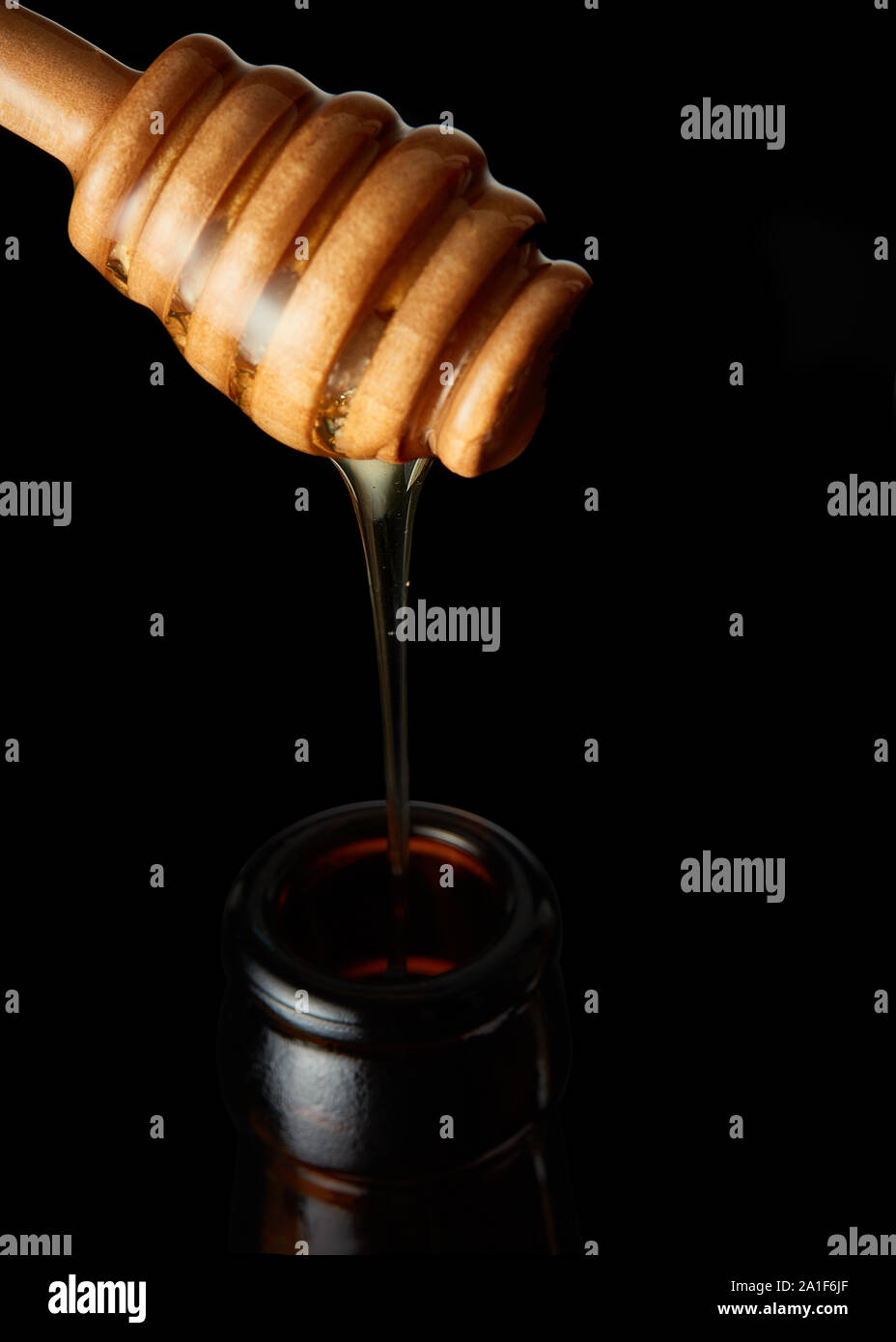 Honig Löffel Honig gießen in Flasche Stockfoto