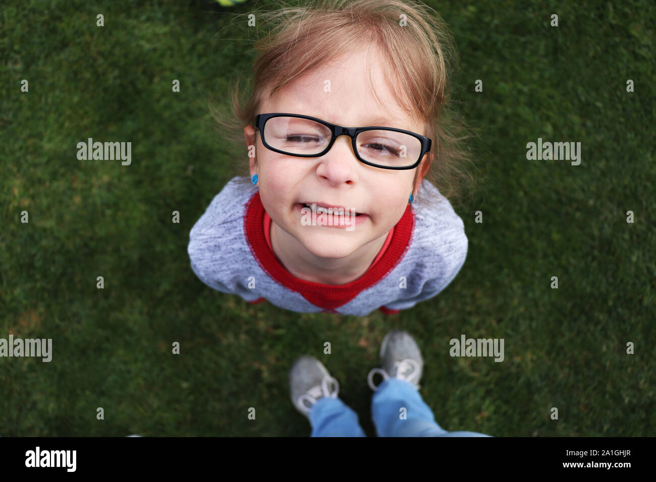 Kind, das mit einem dummen Gesichtsausdruck aufschaut Stockfoto