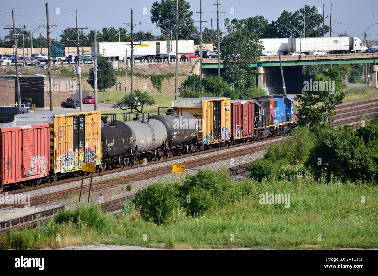 Schiller Park, Illinois, USA. Zwei alte Lokomotiven in der Lackierung ihrer ursprünglichen Straßen führen einen lokalen Güterzug der Canadian National Railway. Stockfoto Schiller Park, Illinois, USA. Zwei alte Lokomotiven in der Lackierung ihrer ursprünglichen Straßen führen einen lokalen Güterzug der Canadian National Railway. Stockfoto