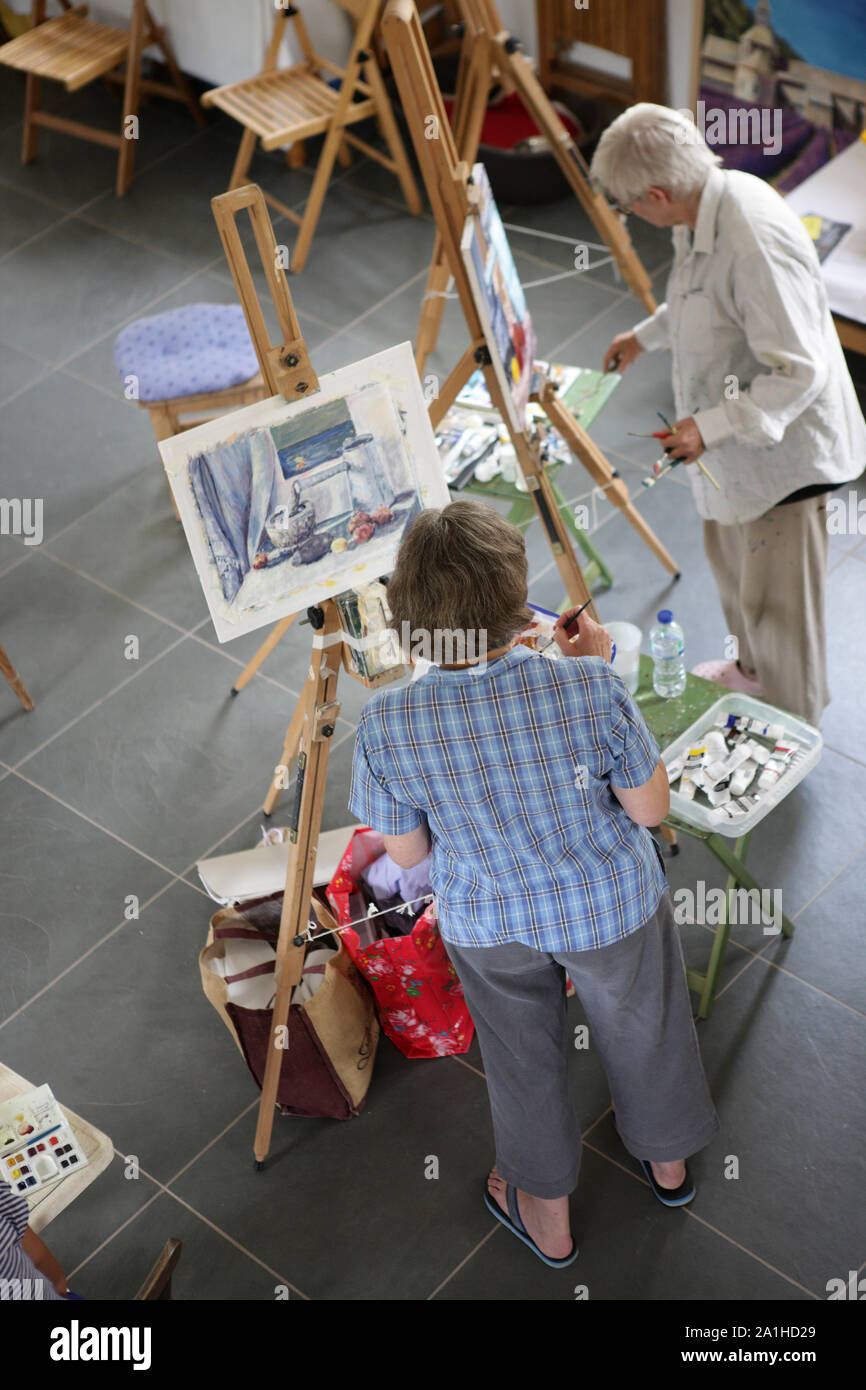 Ältere Studierende in einer kleinen Gruppe Malkurs in Wye Valley Arts Center, Llandogo, Wales. Stockfoto