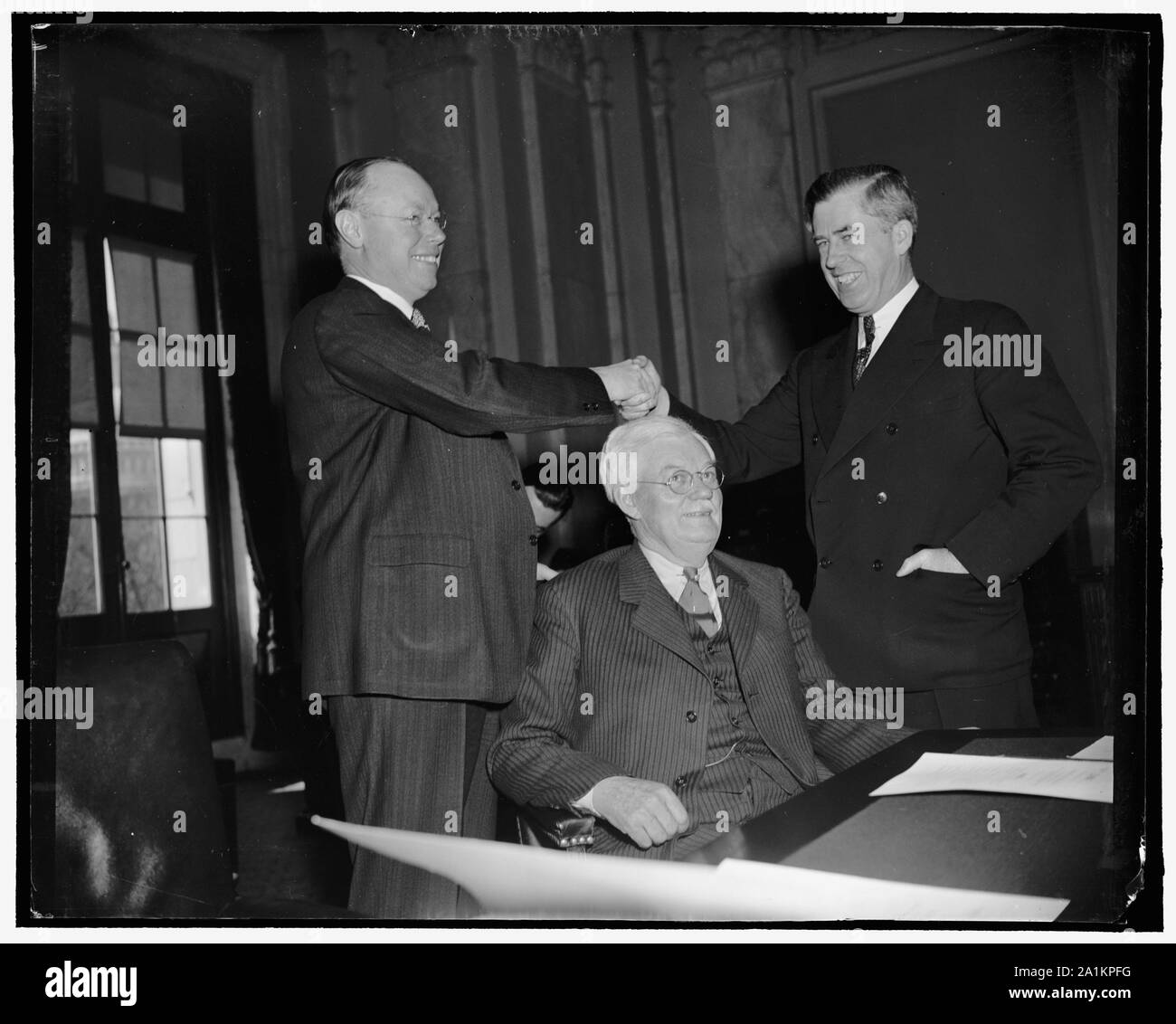 Keine Parteilichkeit hier. Washington, D.C., 16. März. Parteiische Politik wurden heute vergessen, als Sekretär für Landwirtschaft Henry A. Wallace vor dem Senat Banken und Währung Ausschuss erschienen. Wallace, der der Ausschuß erklärt, daß die USA sich für einen "bewaffneten Konflikt zwischen den Währungen" vorbereitet zu sein, wurde von Senator Robert A. Taft, Republikaner begrüßt, über den Kopf eines anderen G.O.P Senator John Townsend, jr., 3-16-39 Stockfoto