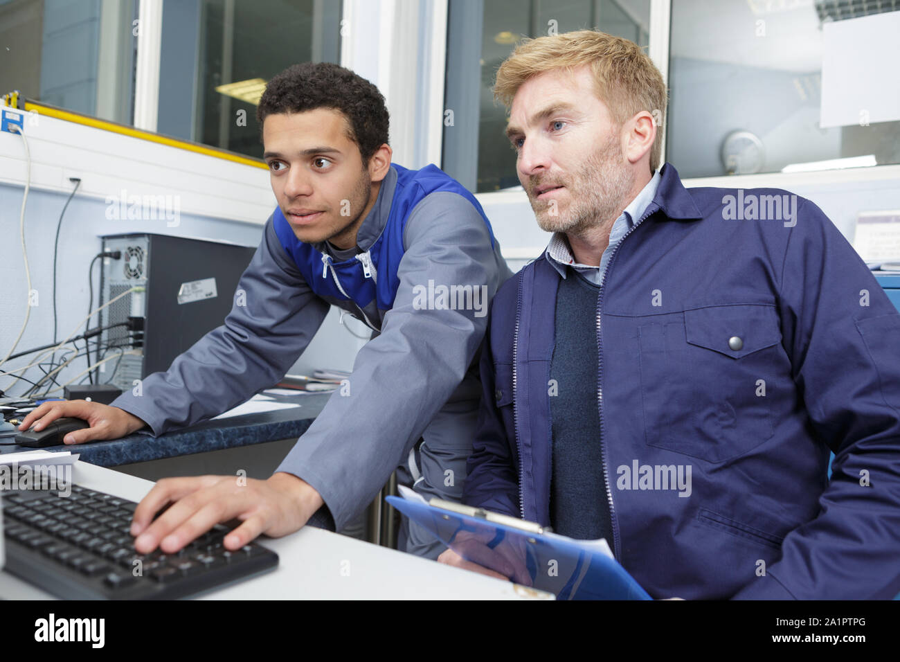 Zwei Männer halten Computer Stockfoto