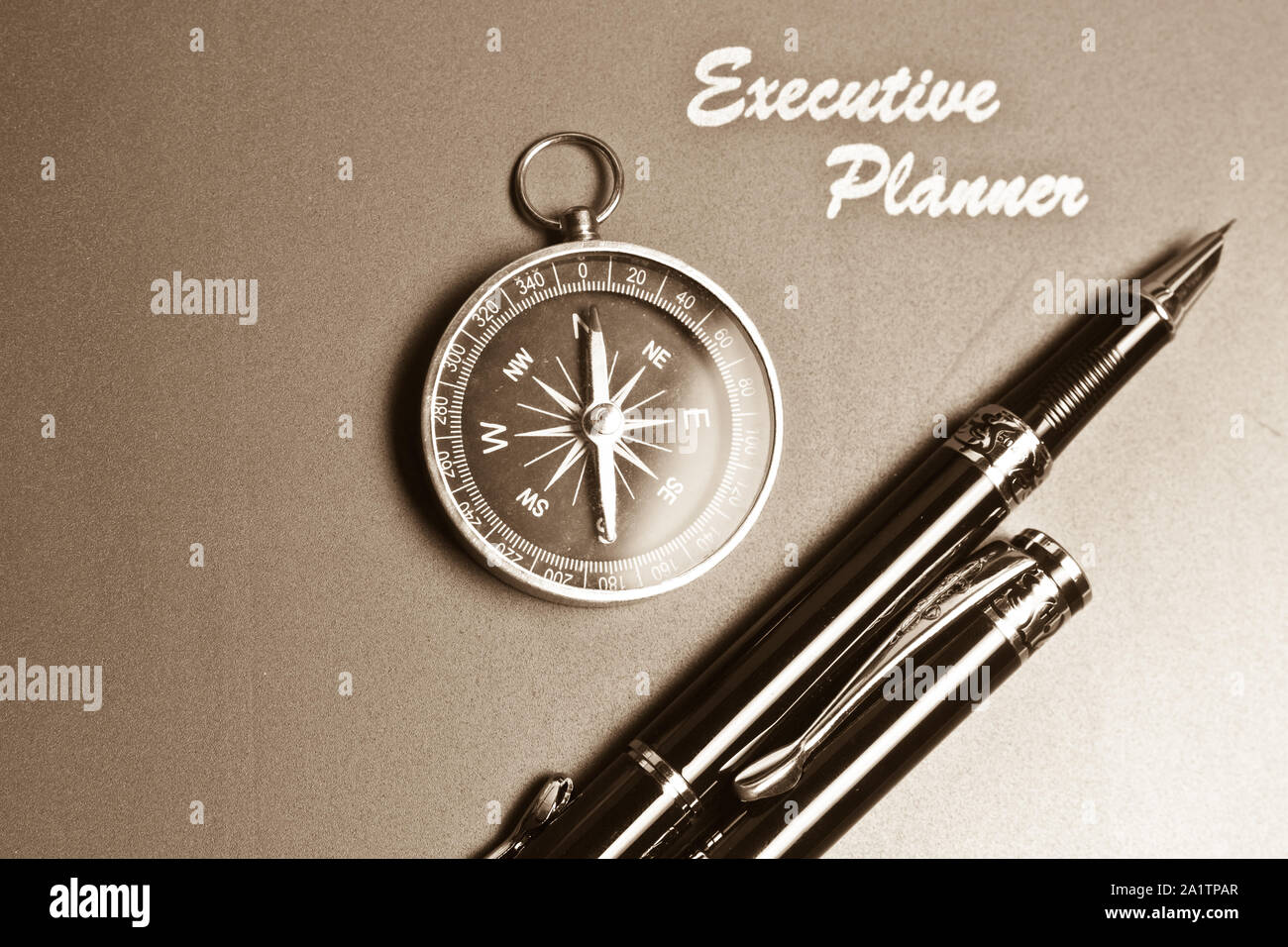 Ein Executive Planer mit einfachen Kompass und zwei Stifte in sepia Ton Stockfoto
