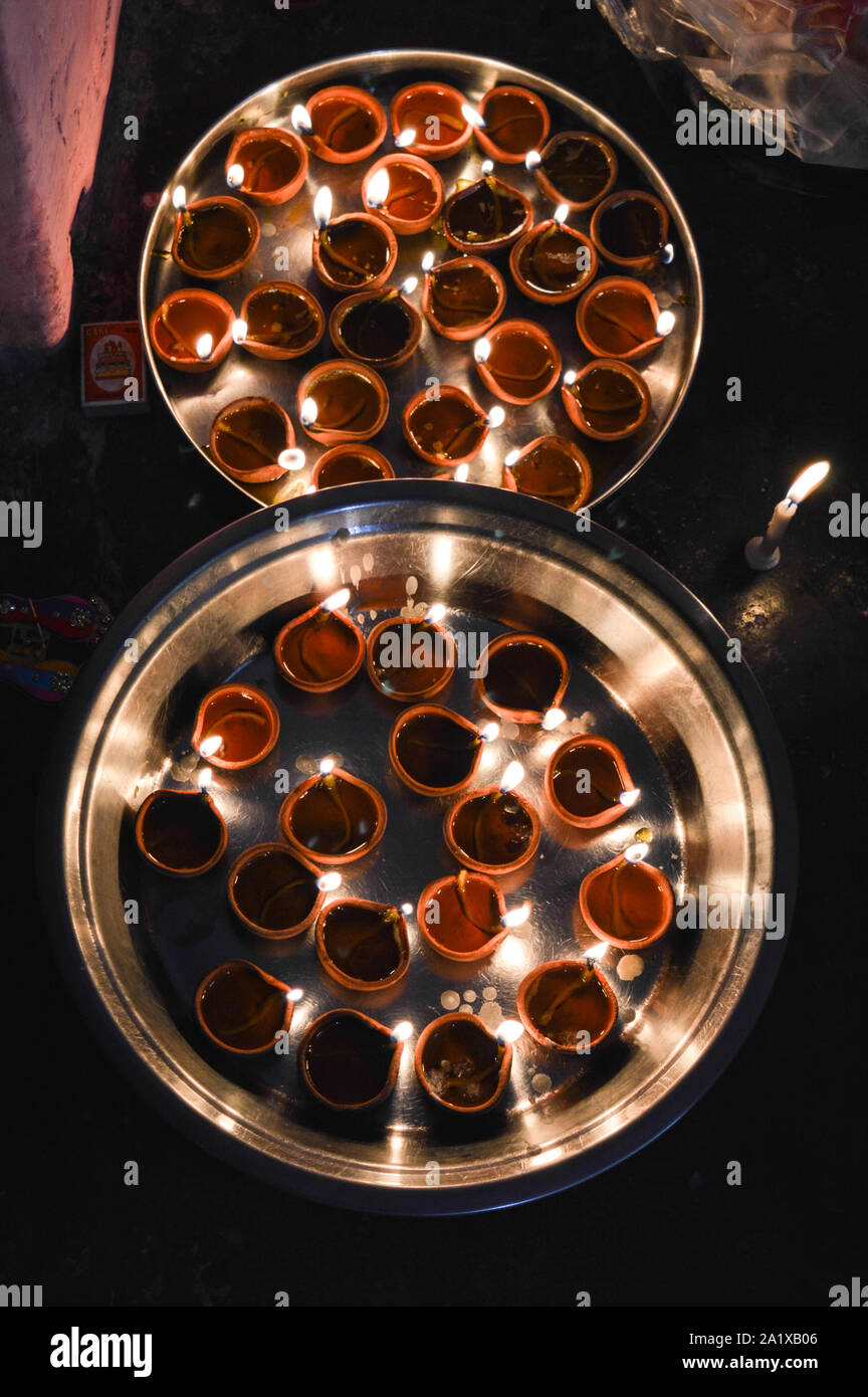 Eine Platte, die mit rose geladen und Kerze auf indischen Festival diwali deepawali mit Feuer am Tisch isoliert Stockfoto