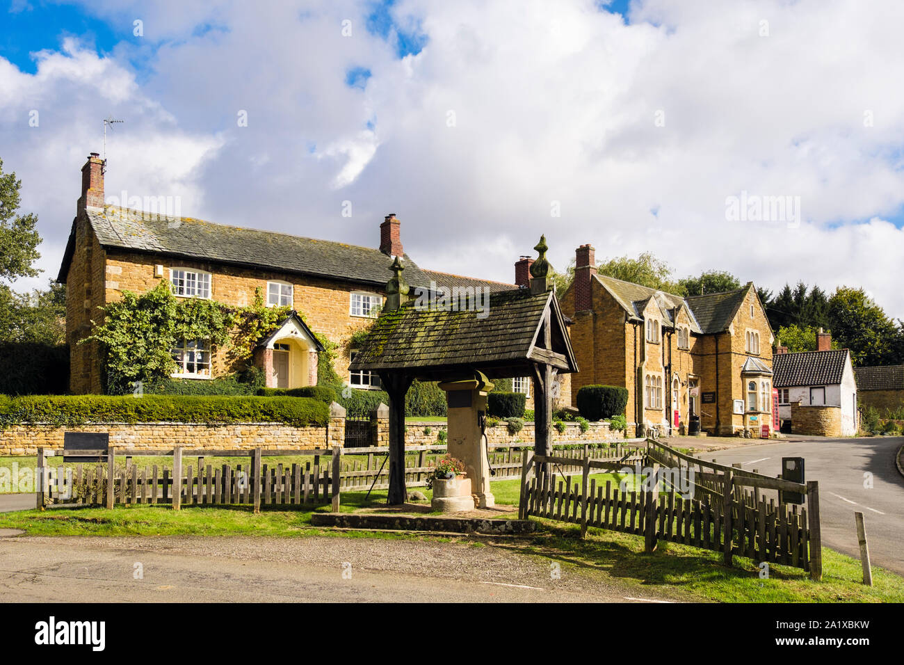 Gebäude um Village Green und alte Pumpe in der Mitte des Knipton, Vale von Belvoir, Leicestershire, England, Großbritannien, Großbritannien Stockfoto