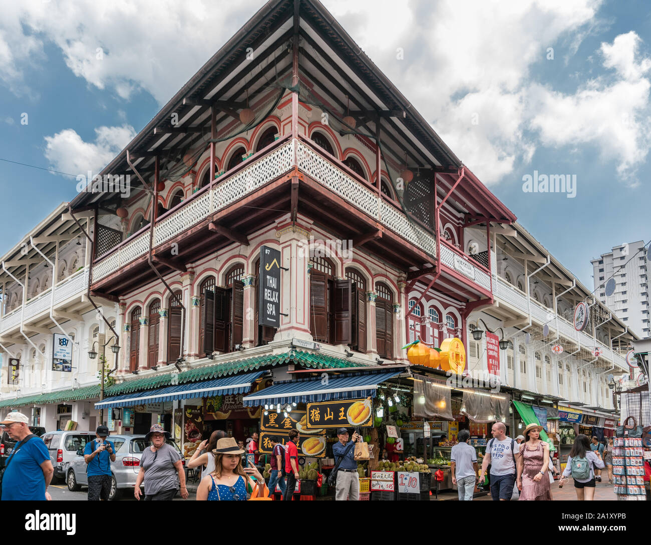 Singapur - 22. März 2019: Chinatown. Historische beige braun Fassade und Balkonen an der Ecke des Trengganu Tempel und Straßen unter blauem Himmel mit Wolken Stockfoto