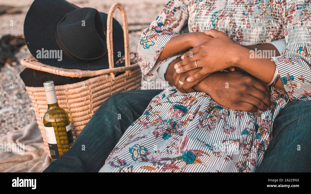 Junges Paar mit Picknick am Strand Stockfoto