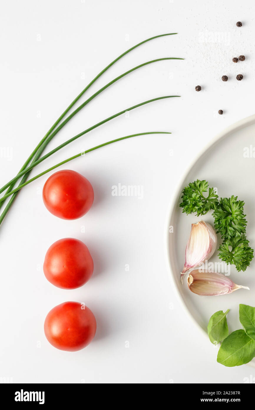 Frische Tomaten, Schnittlauch, Petersilie und Knoblauch Stockfoto