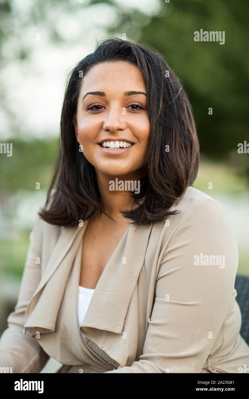 Junge zuversichtlich glücklich Hispanic Frau außerhalb lächelnd. Stockfoto