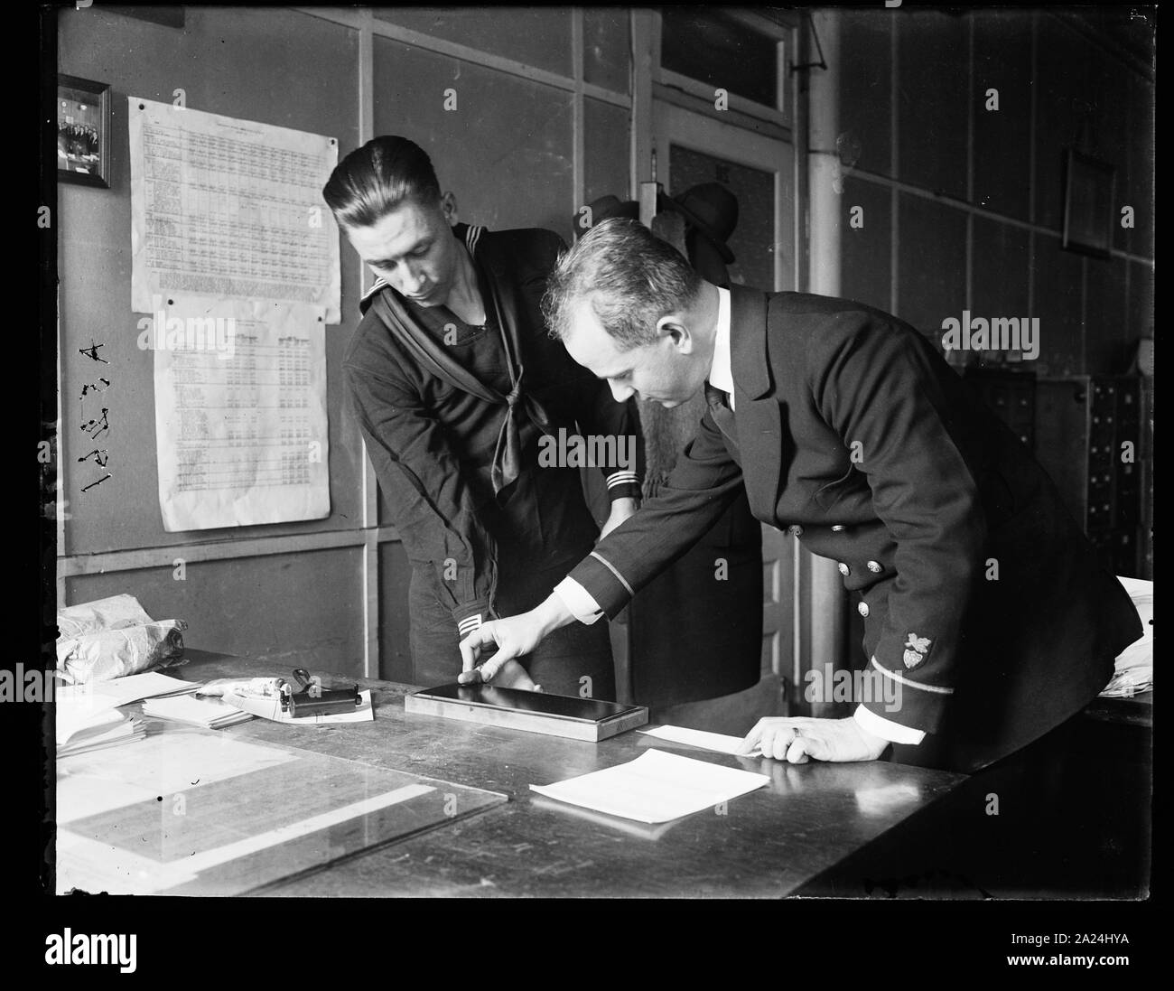 Zahlen angestellte John A. Shaw (rechts) befindet sich in der Aufnahme der Fingerabdrücke von Arthur G. Whaley gezeigt, bei der Küstenwache Headquarters, Washington, D.C. Stockfoto