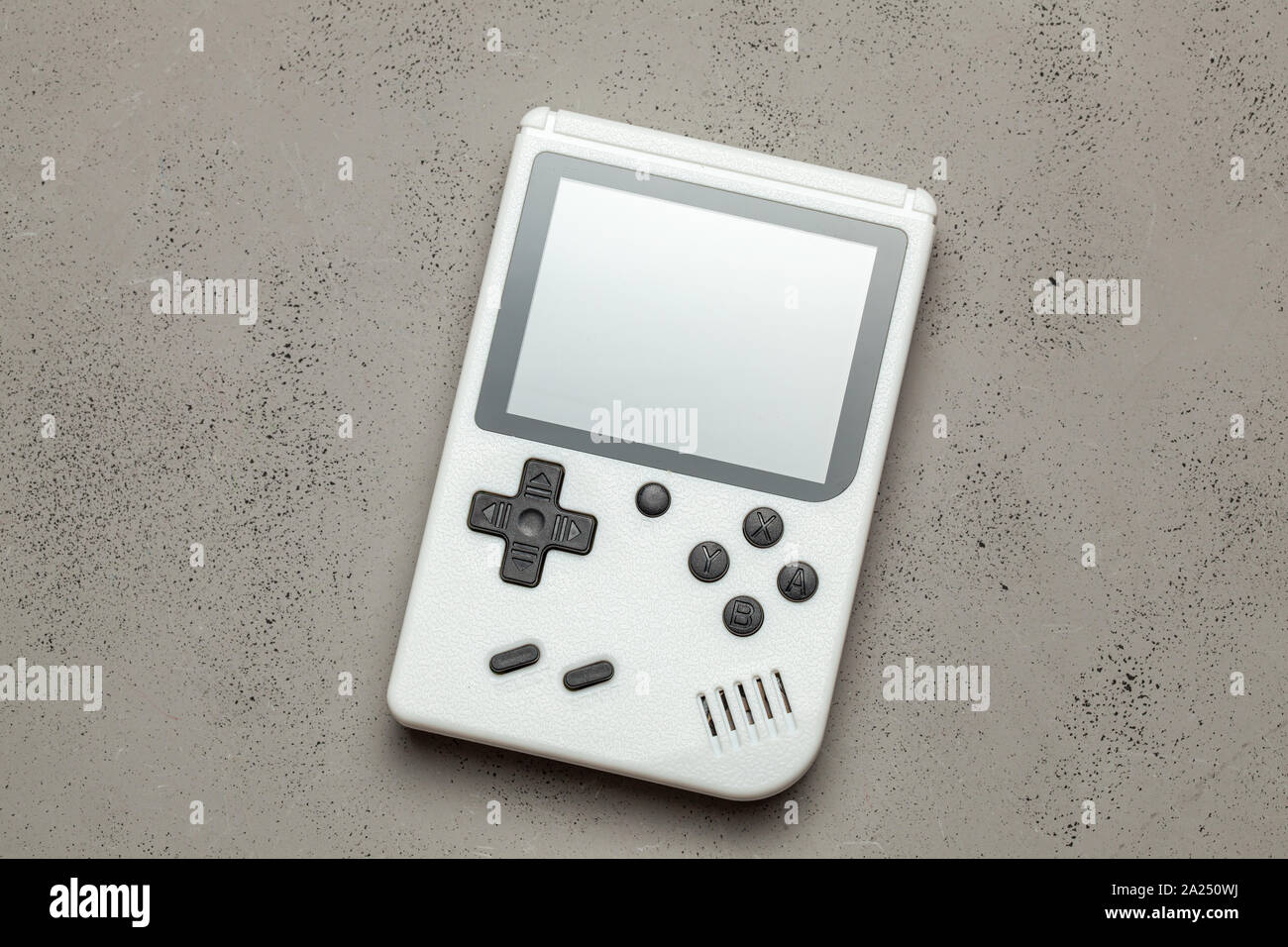 Alte Spielkonsole. Gamepad ist Weiß auf grauem Hintergrund. Stockfoto