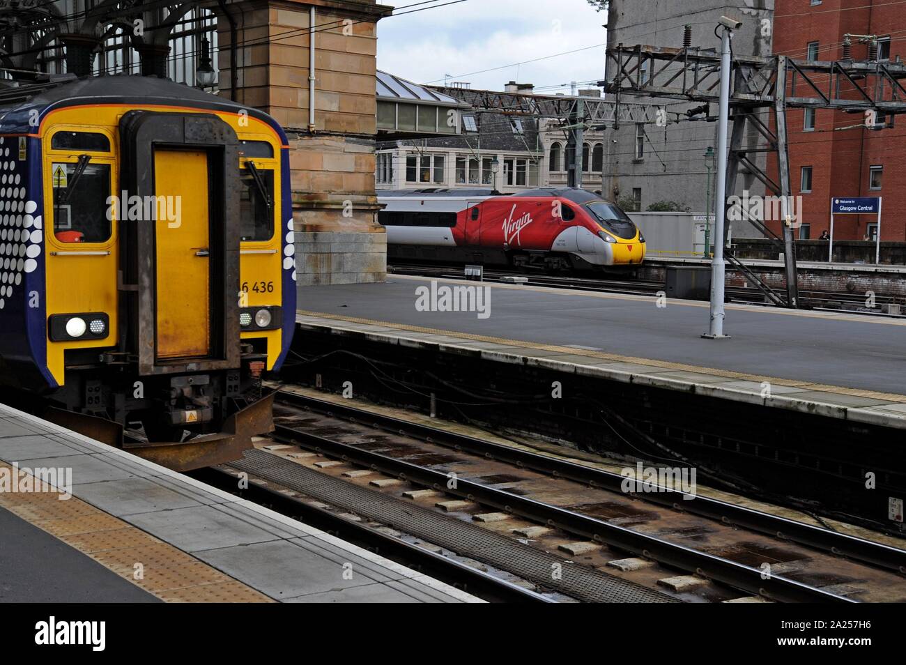 Eine Jungfrau pendolino Zug gesehen warten Glasgow Central Station, für London gebunden zu fahren, mit einem scotrail Klasse 156 Super Sprinter im Vordergrund. Stockfoto