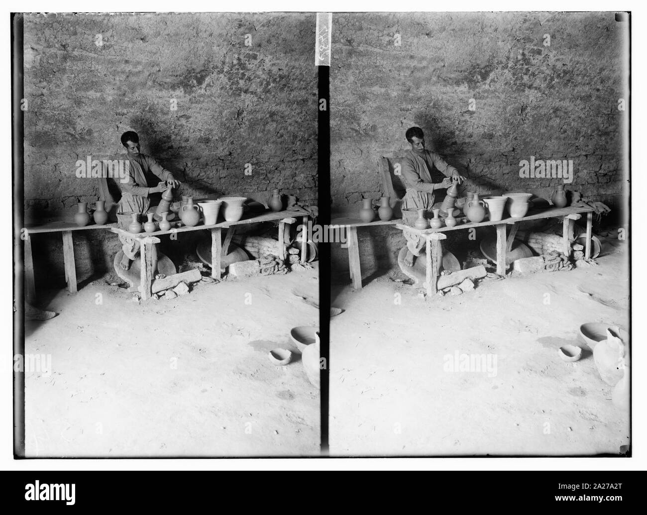 Potter Arbeiten am Rad mit Töpferwaren auf dem Tisch vor ihm an der Felsendom Fliesen Workshop, die Via Dolorosa, Jerusalem. Stockfoto