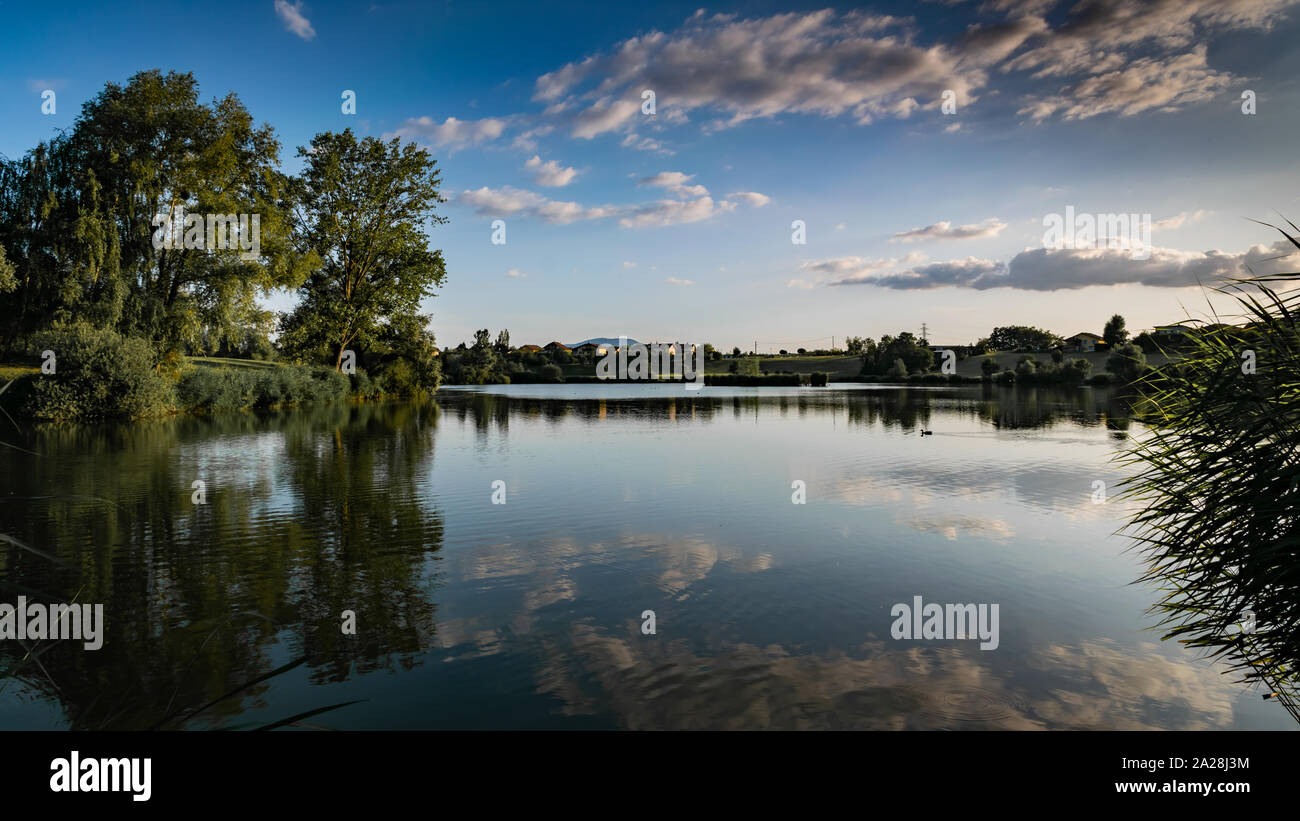 Landschaft, der See, die Berge, Vegetation, Dorf und blauer Himmel mit weißen Wolken, Schwerpunkt in der Mitte des Bild. See Machilly. Stockfoto