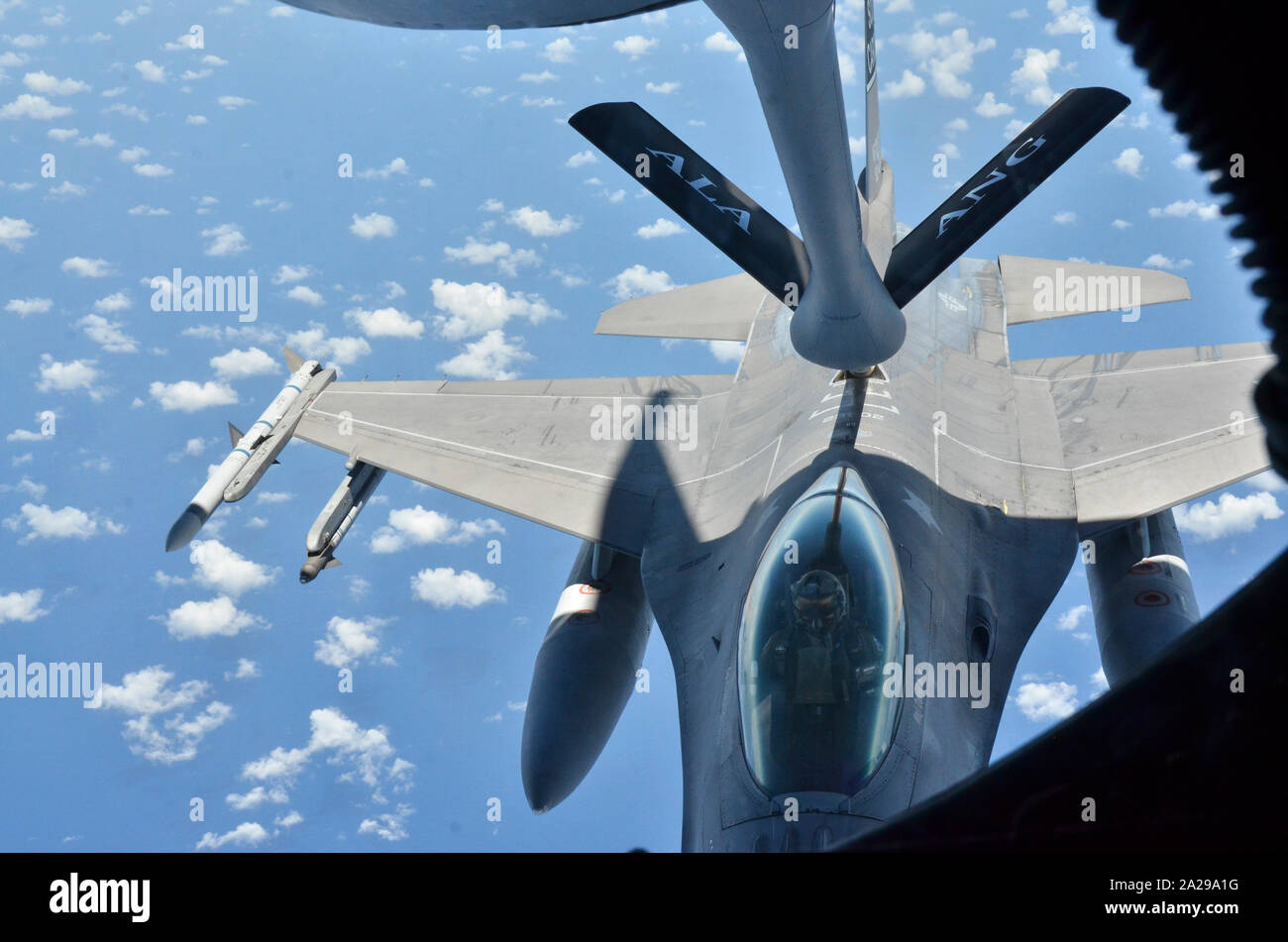 Einer KC-135 Stratotanker R von sumpter Smith Air National Guard Base, Birmingham, Ala., betankt eine F-16 über der Karibik Juli 23., 2019. (U.S. Air National Guard Foto: Staff Sgt. Jim Bentley) Stockfoto