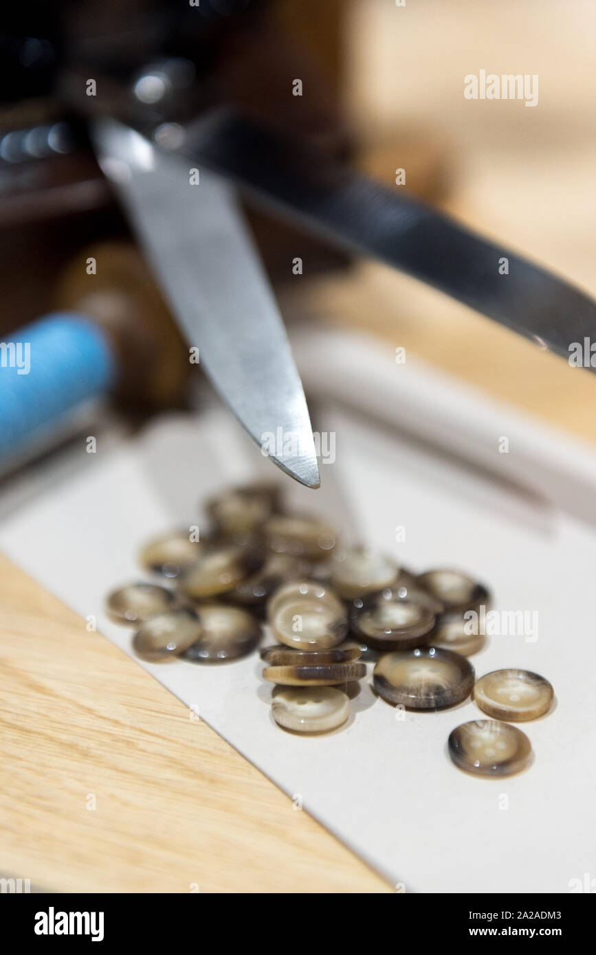 Anpassen der Schere, Tasten und blauem Garn neben Alte Nähmaschine Stockfoto