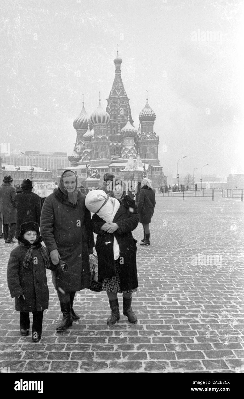 Ansicht der Basilius-kathedrale am südlichen Ende des Roten Platzes in Moskau. Im Vordergrund ein Familie posiert für ein Foto. Stockfoto