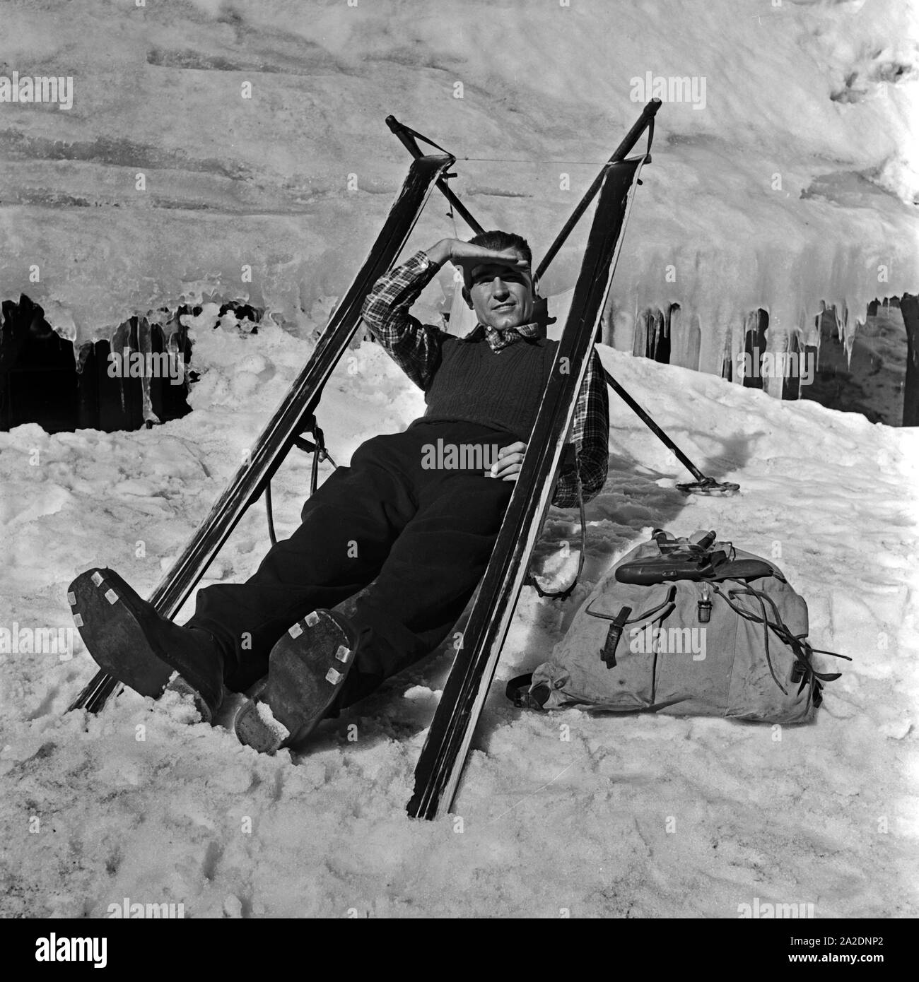Ein Skiurlauber hat sich aus-Skifahrer einen Sitz gebaut und macht eine Pause, Deutschland 1930er Jahre. Ein Ski touristische erbaut, der Sitz von seinen Skiern und haben jetzt eine Pause, Deutschland 1930. Stockfoto