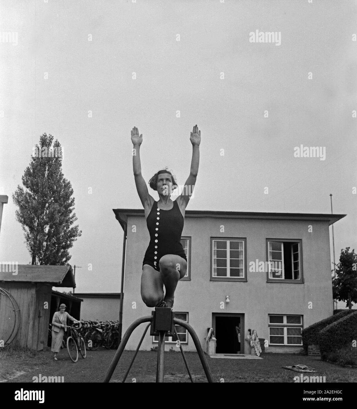 Eine Frau bei einer Übung am Schwebebalken in der logau Bahnstation Musterschule für Frauenturnen in Hannover, Deutschland 1930er Jahre. Eine Frau, eine Übung am Schwebebalken am Logau Schule für Frauen Gymnastik in Hannover, Deutschland 1930. Stockfoto