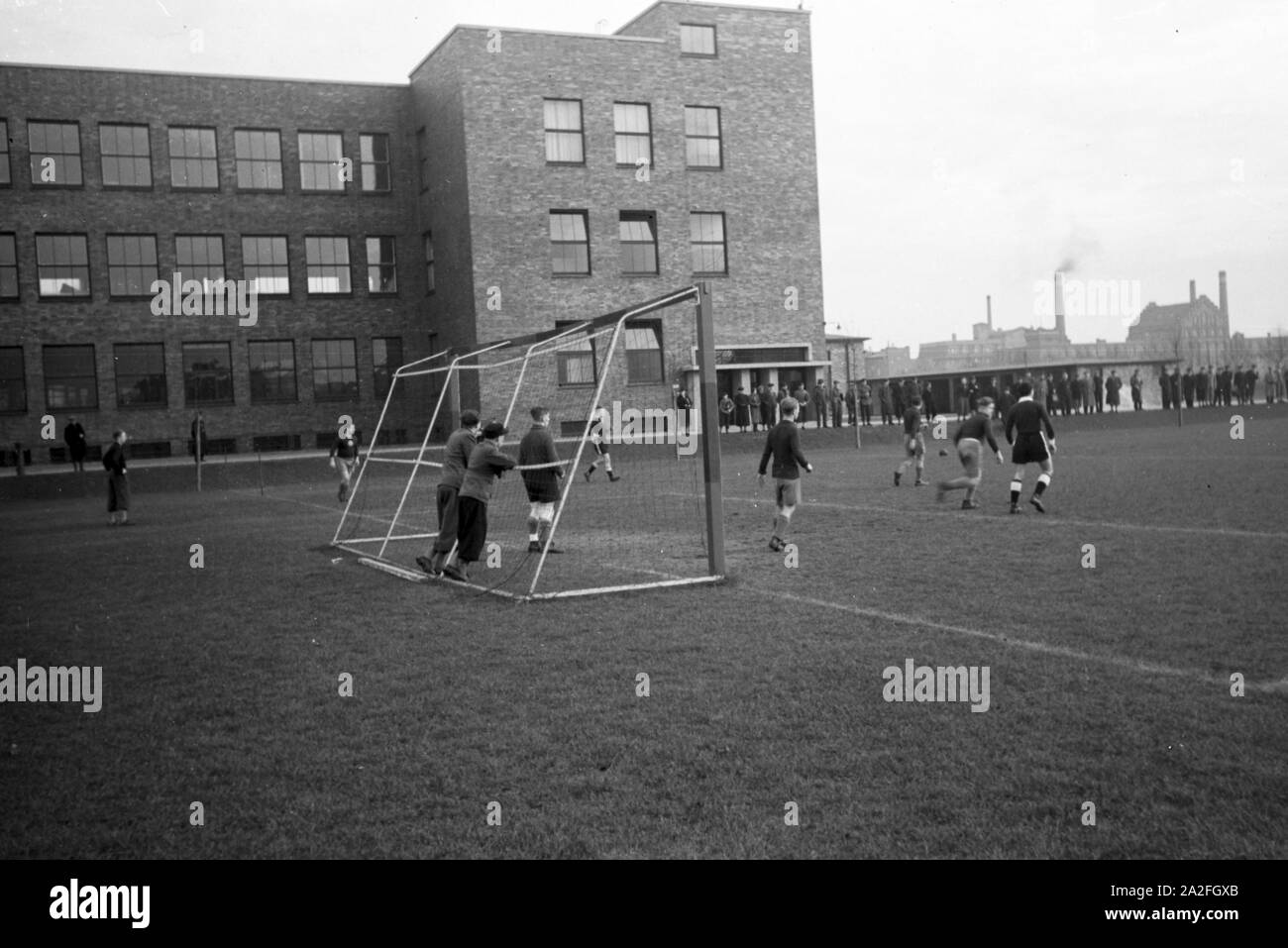 Zuschauer beobachten ein Fußballspiel auf dem Gelände der Roth-Büchner GmbH, Berlin, Deutschland 1930er Jahre. Die Zuschauer eines Fußballspiels auf den Bereich der Roth-Büchner GmbH, Berlin, Deutschland 1930. Stockfoto