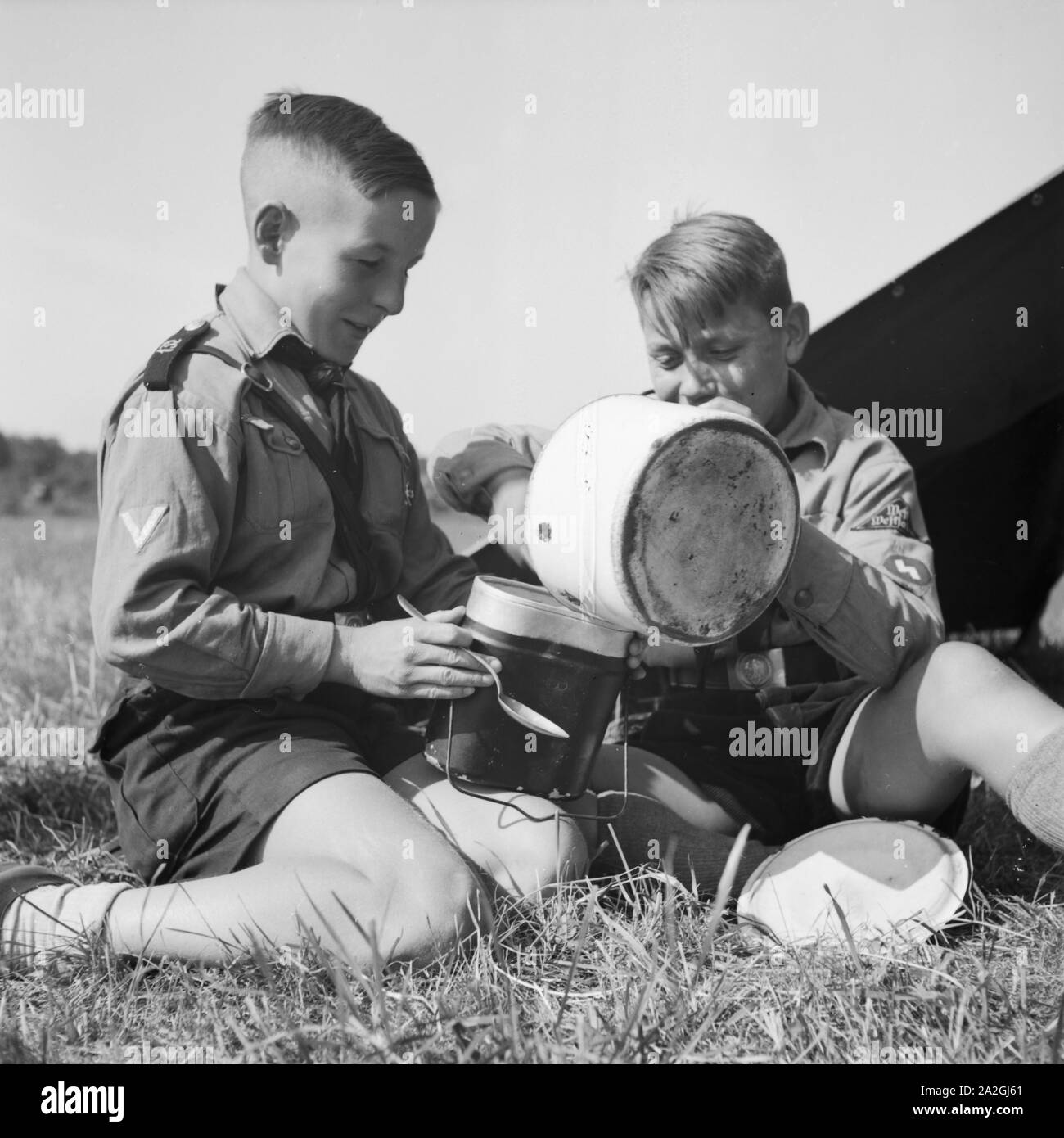 Zwei Hitlerjungen im Zeltlager beim Essen, Deutschland 30er Jahre. Zwei Hitler Jugend zu Mittag essen, Deutschland 1930. Stockfoto