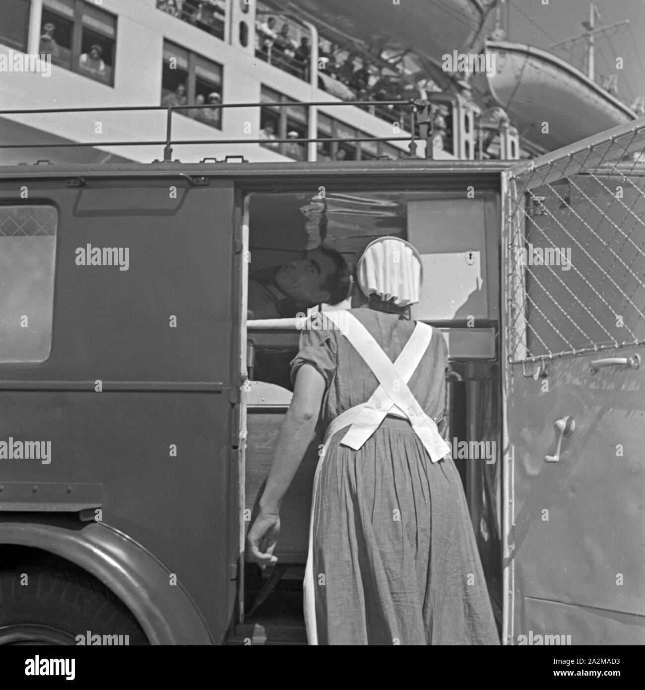 Original-Bildunterschrift: LAZARETTSCHIFF "Wilhelm Gustloff" - Eine Krankenschwester verabschiedet sich von einems Pflegebefohlenen nach der Landung in Kiel / dessen Verladung in einen Sanitätskraftwagen. Krankenhaus Schiff "Wilhelm Gustloff" - eine Krankenschwester Abschied von einem verwundeten Soldaten, nachdem er zu einem Krankenwagen van berücksichtigt wird. Stockfoto