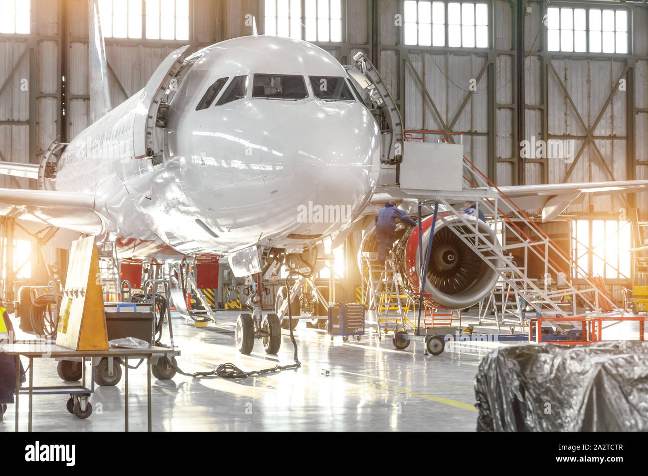 Flugzeuge Jet bei der Wartung von Motor und Rumpf prüfen und beheben Sie die in Airport Hangar Stockfoto