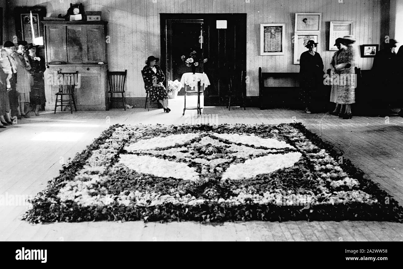 Negative - Mildura, Victoria, 1938, einen geblümten Teppich auf dem Boden von St. Andrew's Hall, Mildura. Eine Frau, die an der Rückseite der Halle sitzt, andere Frauen stehen an den Seiten Stockfoto