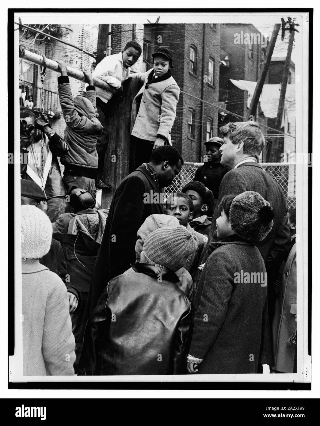 Senator Robert Kennedy und der cbcc Donald F. Benjamin melden Sie Kinder am Spielplatz; Senator Senator Robert F. Kennedy (D-NY) und Donald F. Benjamin (Mitte) von der zentralen Brooklyn Koordinierungsrat von Kindern ausserhalb eines Gebäudes umgeben.; Stockfoto