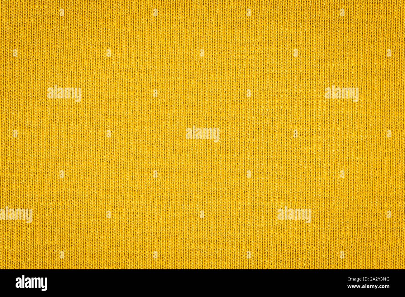 Textur von echten gelben Pullover, Textil- Hintergrund. Zusammenfassung Hintergrund Stockfoto