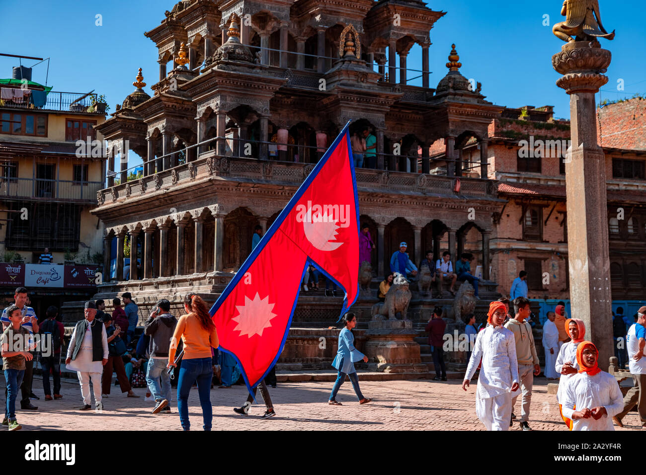 Junger Mann mit National Flagge Nepal über einen hellen Tag in Patan Durbar Square. Stockfoto
