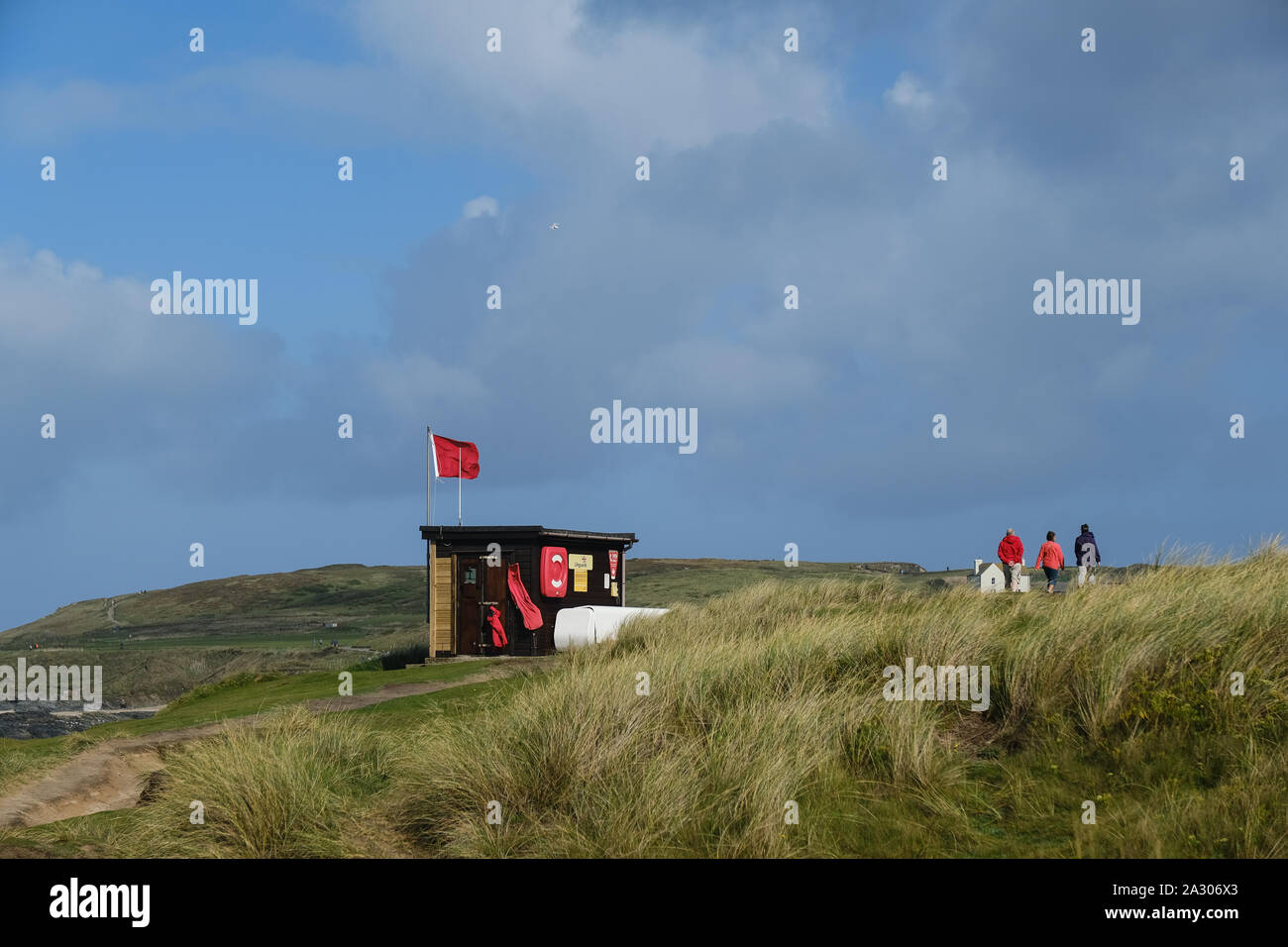 Eine rote RNLI Lifeguards Warnung Fahne über den Strand fliegen an Godrevy in Cornwall. Stockfoto