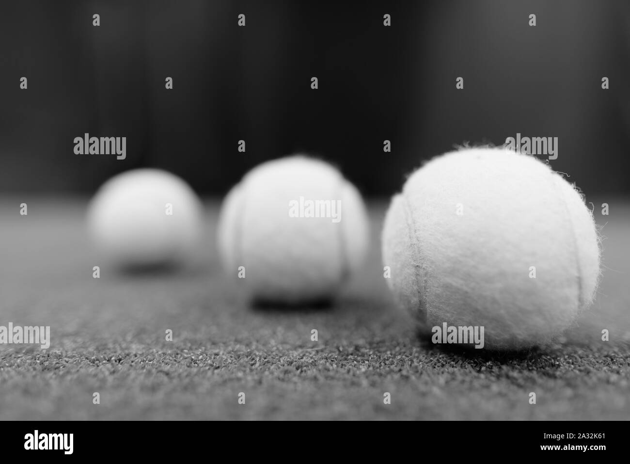 Tennis Bälle auf dem Boden geschossen in Schwarz und Weiß Stockfoto