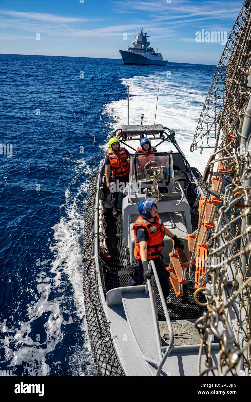 191003-N-UB 406-0106 GOLF VON CADIZ (Okt. 2010) 3, 2019) Segler aus der norwegischen Marine Fridjof Nansen-Klasse Fregatte HNoMS Thor Heyerdahl (F-314) begeben sich die US-Marine geführte Anti-raketen-Zerstörer USS Gridley (DDG101) eine integrierte Training Team Übung auf dem Schiff Flight Deck zu führen. Gridley ist unterwegs auf einem geplanten Einsatz als Flaggschiff der Standing NATO Maritime Group eine maritime Operationen durchzuführen und einen kontinuierlichen maritime Fähigkeit zur NATO im nördlichen Atlantik. (U.S. Marine Foto von Mass Communication Specialist 2. Klasse Cameron Stoner) Stockfoto