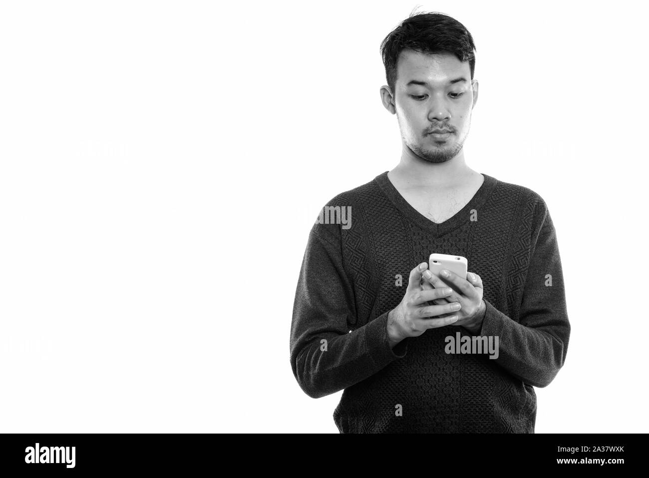 Studio geschossen von jungen asiatischen mit Handy Mann Stockfoto