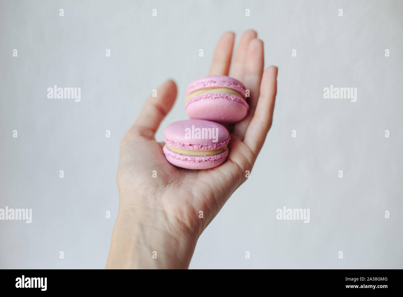 Woman's Hand zwei makronen Stockfoto
