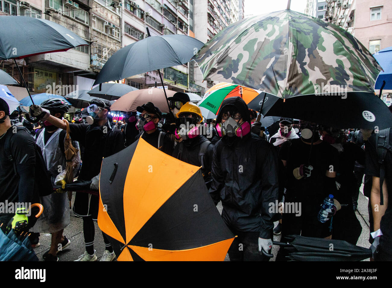 Die Demonstranten schirmt sich mit Regenschirmen während der Demonstration. Eingabe der 18 Wochenende der Unruhen, Demonstranten marschierten im Regen nach einer Anti-mask Gesetz wurde in einer Bemühung, Demonstrationen abzuhalten. Die Demonstranten skandierten Parolen und fuhr fort zu Fragen für die fünf Forderungen erfüllt werden. Die Demonstranten zu Zusammenstößen zwischen Polizei und wurden mit Gas, Gummigeschossen getroffen, und einer Wasserkanone bis mehrere wurden schließlich verhaftet. Stockfoto