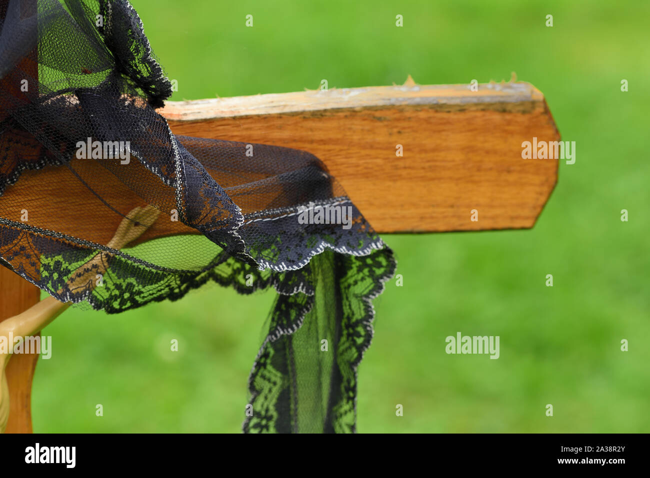 Close-up und der Hintergrund eine einfache Holzkreuz in einem christlichen Friedhof mit einem schwarzen Band Stockfoto