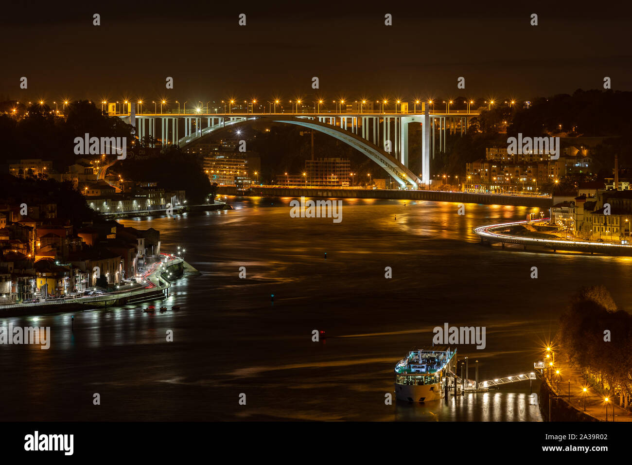 Stadt Porto bei Nacht, mit Blick über den Fluss Douro mit Arrabida Brücke an Abstand Stockfoto